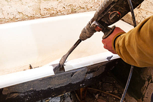 Dismantling the bathtub with a jackhammer.