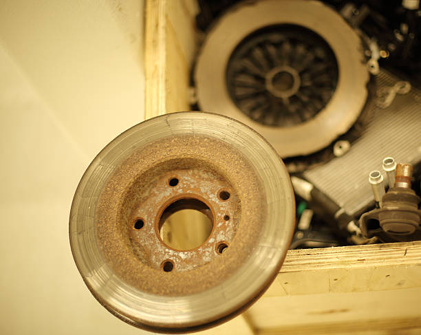A car with the front wheel removed where you can see the brake disc.