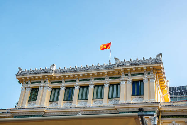 The Saigon Central Post Office in Ho Chi Minh City, completed in 1891, is a stunning example of French colonial architecture designed by Gustave Eiffel (or his architectural firm). Located in District 1 facing Notre-Dame Cathedral, the building features a striking Gothic and Renaissance Revival façade with arched windows, decorative iron work, and cream-yellow colouring typical of French Indochina.
