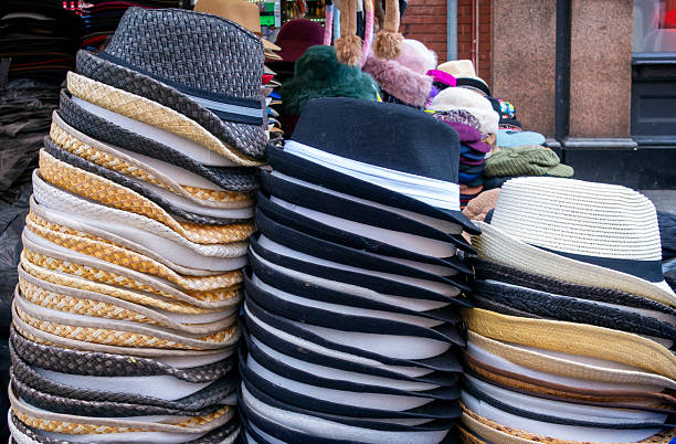 Piles of assorted hats on a market stall in Earlham Street, Camden, London.