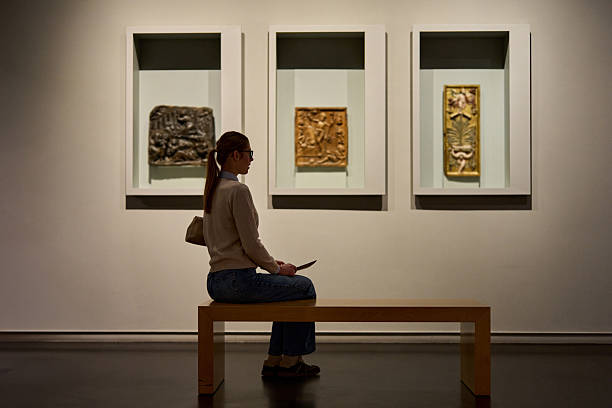 Visitor in historical museum looking at art object