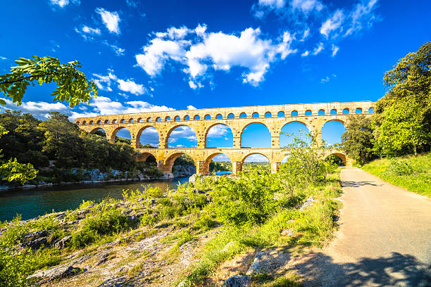 Scenic Pont du Gard ancient Roman aqueduct from first century and the river of Gardon view, southern France.