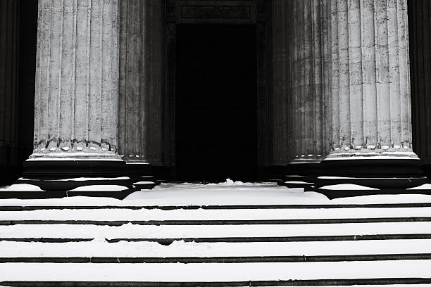 Row of columns covered in snow, winter scene.
