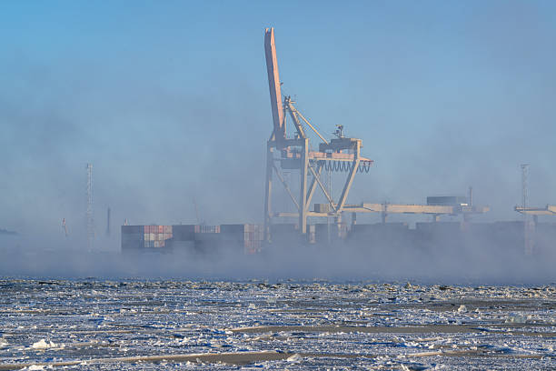 Frozen Daugava River on a winter morning and port cranes