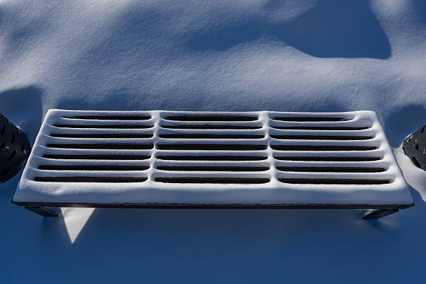 Snow-covered park bench in the morning light