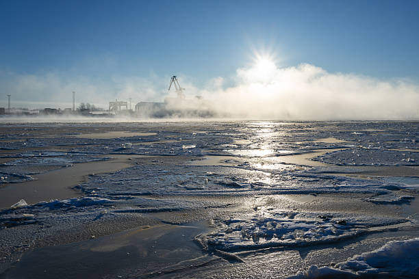 Frozen Daugava River on a winter morning and port cranes