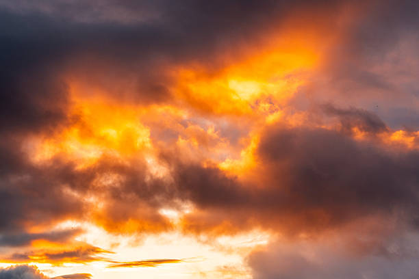Dramatic golden hour sunset painting clouds with warm colors over the arctic sky