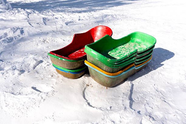 Sled in a backyard with snow and fence