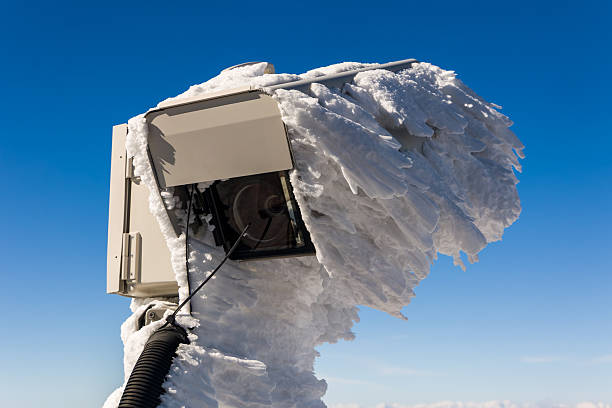 Surveillance camera covered in heavy rime ice and snow on a mountain summit