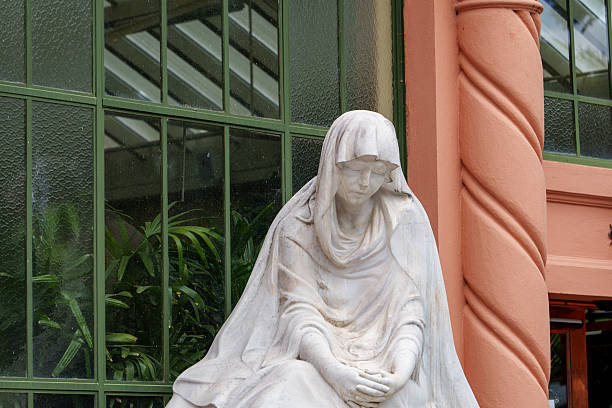 Afetna, Saipan, Northern Mariana Islands: polychrome figure of Saint Anthony wearing a cowl with bay Jesus outside San Antonio Church - St. Anthony of Padua / Lisbon was a Portuguese Roman Catholic priest and friar of the Franciscan Order. Santo Antonio or Fernando António de Bulhões, his birth name, was born in Lisbon, Portugal, in 1195. From a noble and wealthy family, he was the only son of Martinho de Bulhões, an officer in the army of King Afonso and Teresa Taveira. He had an irresistible power with words and Saint Francis named him the Order's first Theology Reader.