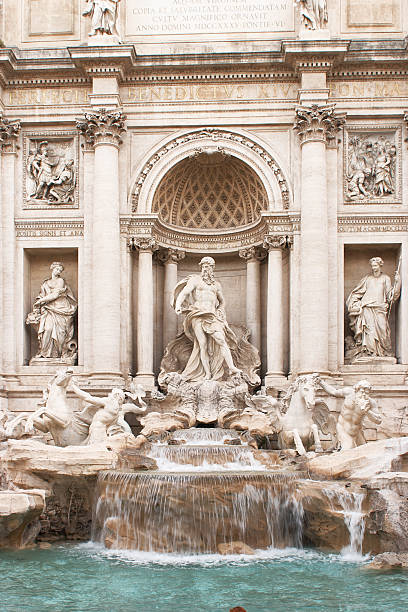 Roman trevi fountain close up displaying baroque architecture with the sculpture of neptune and flowing water