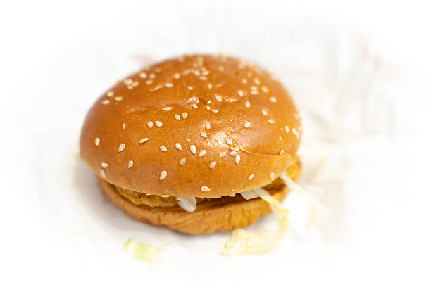 Sesame seed burger with lettuce on white paper background