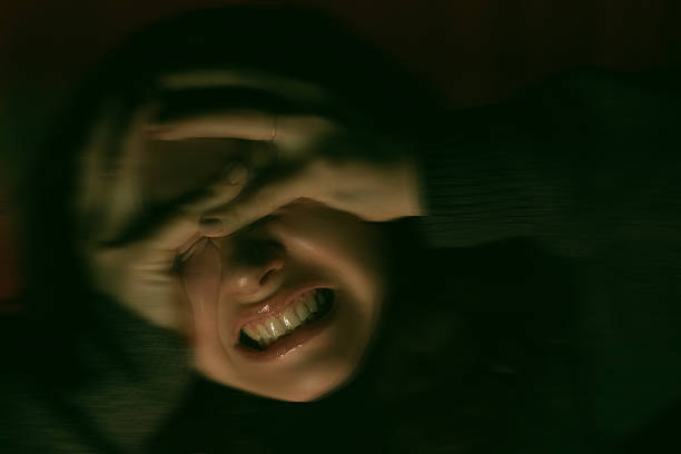 young  woman falling into despair and clutching her head