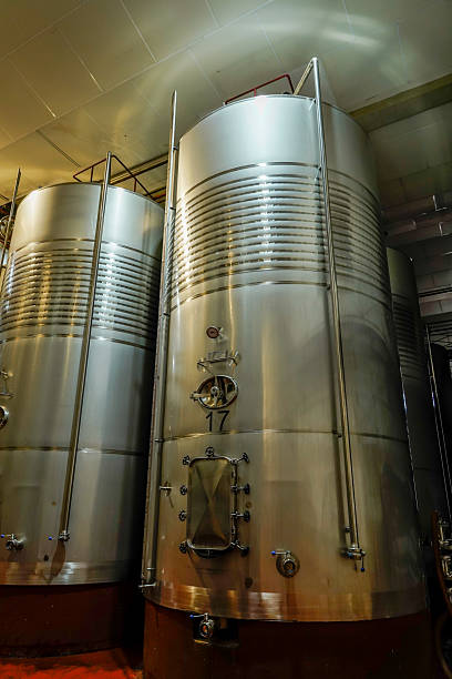 Stainless steel tanks storing wine in a modern winemaking facility