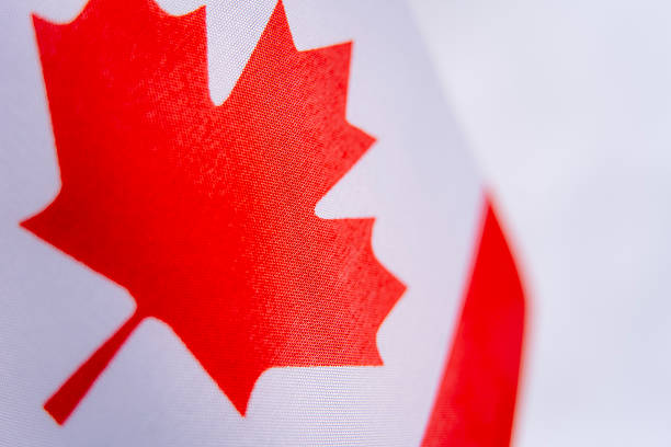 Canada flag featuring a red maple leaf in the center, flanked by two vertical red bands on a white field. High quality photo