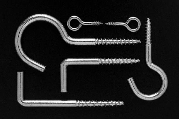 Set of metal screw hooks and eye bolts displayed on a black background. Perfect for industrial catalogs, hardware identification, and engineering product imagery.