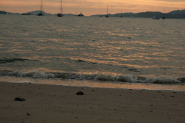 Picture with sunset and boats in the background