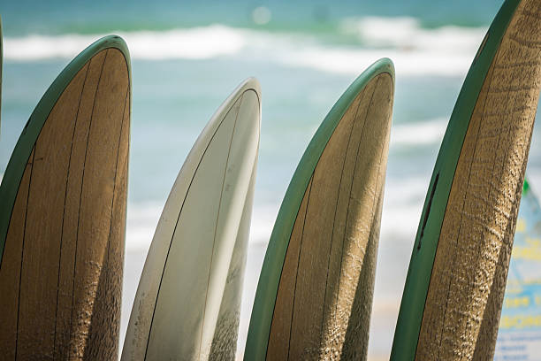 Four surfboards are standing on the beach with sea waves background.Da Nang - Vietnam.