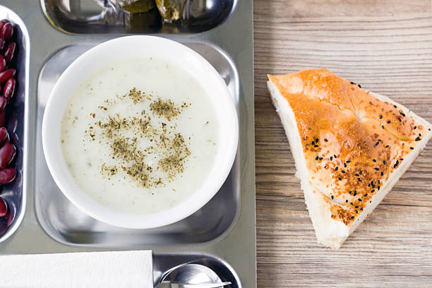 Traditional Turkish Ramadan soup, served on a stainless steel serving food tray with Ramadan Bread.