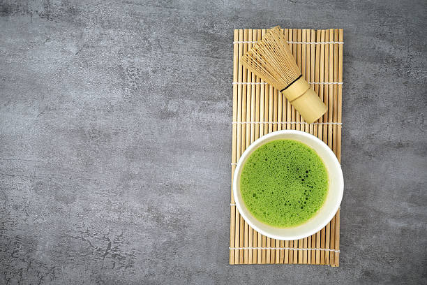 Green matcha kit on stone texture background. Copy space