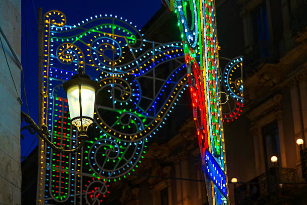Rome, Italy - January 6, 2025: on the left-foreground-detail of the Christmas tree. On the background, crowded Piazza di Spagna and Via Condotti lighted for Christmas.