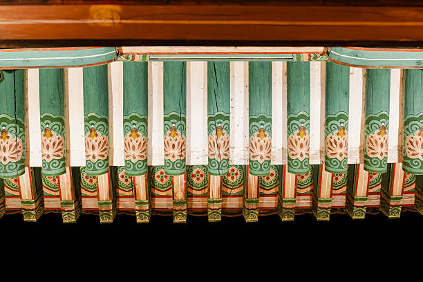 The vibrant colours of traditionally painted wooden beams and curving pagoda eaves of a pavilion in Gyeongbokgung, Seoul, South Korea. ProPhoto RGB profile for maximum color fidelity and gamut.