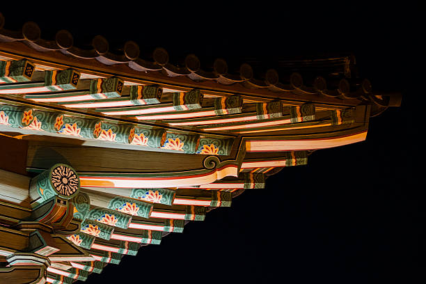 A striking, close-up captures the intricate details of an architectural structure's eaves, adorned with vibrant colors.