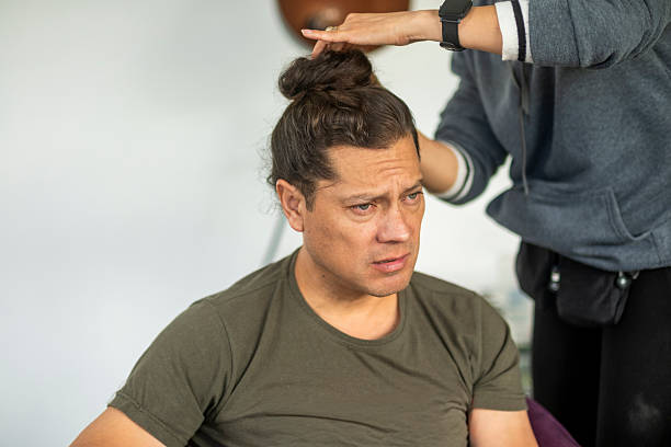 young man with long hair being styled by a professional stylist