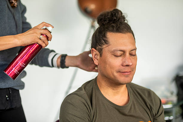 young man with long hair being styled by a professional stylist