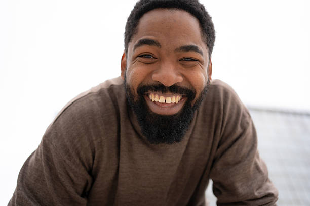 Adult african american man with a beard and gap teeth smiling broadly
