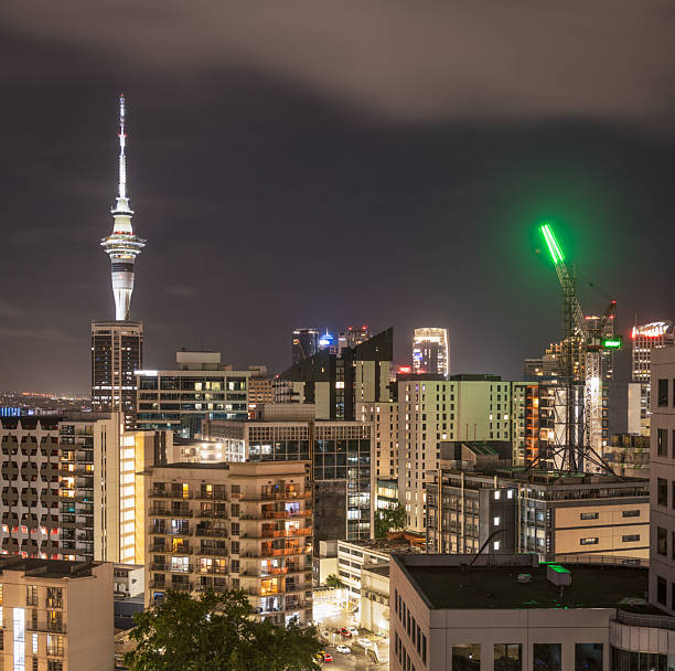 The Sky Tower and other buildings in Auckland's CBD illuminated at night.