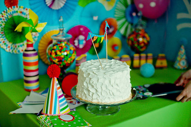 cake with creamy icing displayed in lively party setup full of decorations and candy jar. Joyful birthday atmosphere, colorful dessert theme and festive celebration mood. High quality photo