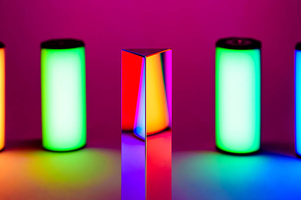 Studio photo with multiple colored lights representing the rainbow with glass prism reflecting colors and patterns.