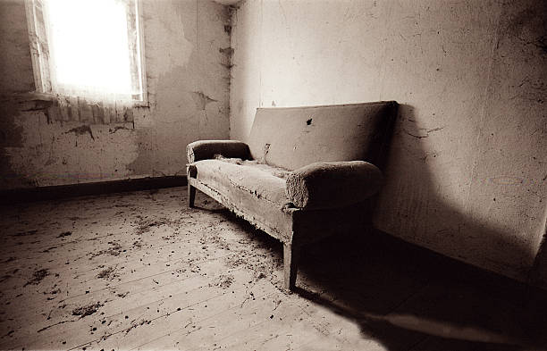 A very dusty old couch in an abandoned building