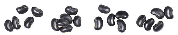 Black beans isolated on white background, top view. Organic legume ingredient for healthy vegan protein diet, cooking concept, raw food texture and nutrition source.