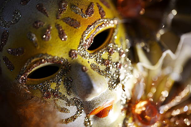 A beautifully crafted mask featuring intricate designs and colorful tarot card decorations captures the essence of a lively festival. The glossy finish reflects the atmosphere of joy and mystique.