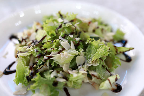 Food photography. Cesar salad served on a tray. The salad has chicken, lettuce, onions and more toppings. Perfect for a summer healthy lunch.