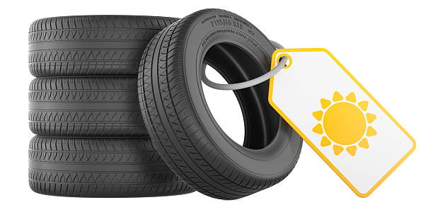 Car Wheel with Tire, A car tire mounted on a silver alloy wheel rim sits on a bright orange surface of auto repair garage. Car maintenance
