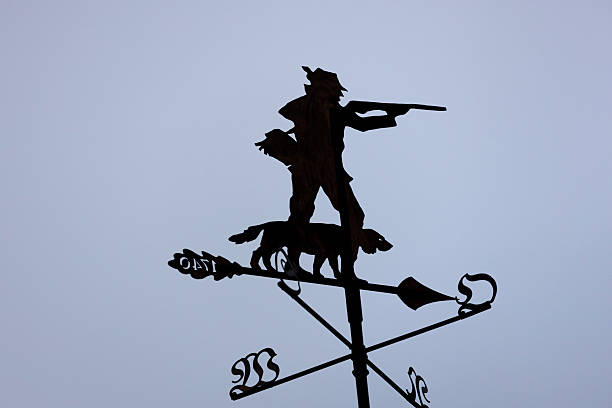 a hunter and dog sculpture in front af the sky