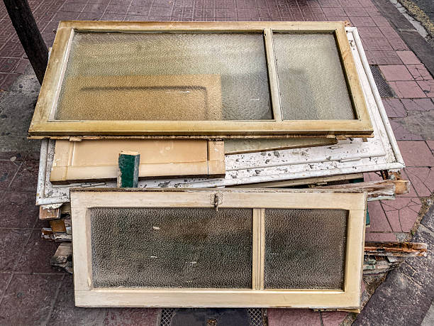 High angle close-up view of vintage wooden window frames and panels left on the sidewalk in the city of Valencia, Spain