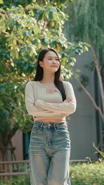 Relaxed woman standing outside and taking in fresh air