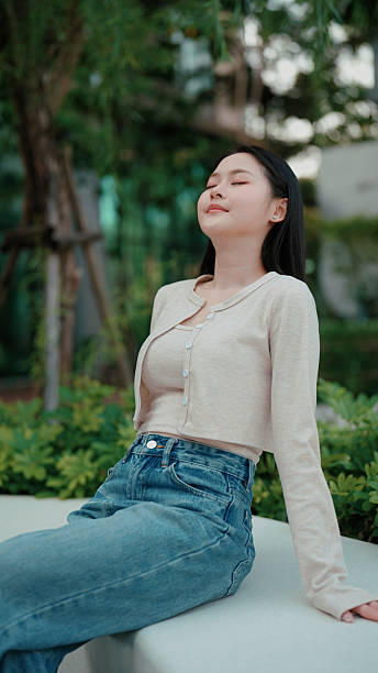 Serene outdoor moment with woman resting in a green environment
