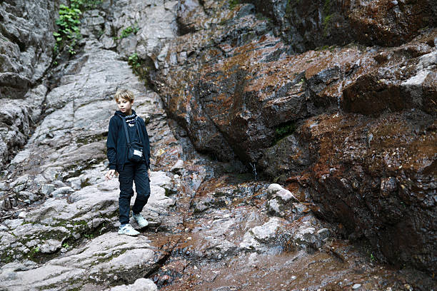 Boy on hiking excursion at Cossack waterfall in Teberda Nature Reserve stock photo