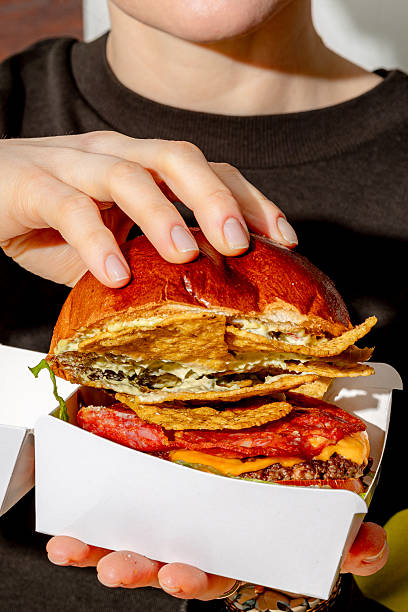 Girl holding a box of burgers with space for text