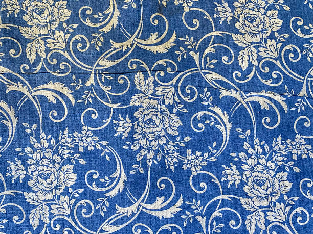 Close-up front view of a floral jacquard upholstery fabric featuring an intricate botanical pattern in blue and white