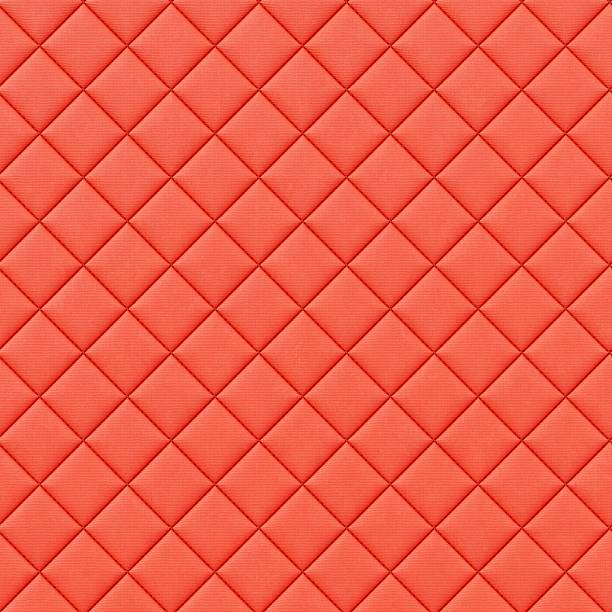 High resolution 3D illustration of a coral red quilted fabric or leather texture with a geometric diamond pattern. Soft padded background suitable for design projects.