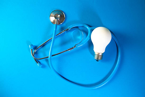istock Stethoscope and light bulb on blue background. Concept of idea. 2262123545