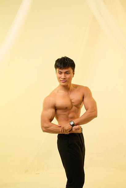 Athletic male model posing confidently while showcasing a strong and well-defined physique. The footage emphasizes muscle tone, fitness aesthetics, and healthy lifestyle concepts. Ideal for fitness promotions, gym advertising, bodybuilding themes, sports branding, and motivation content.