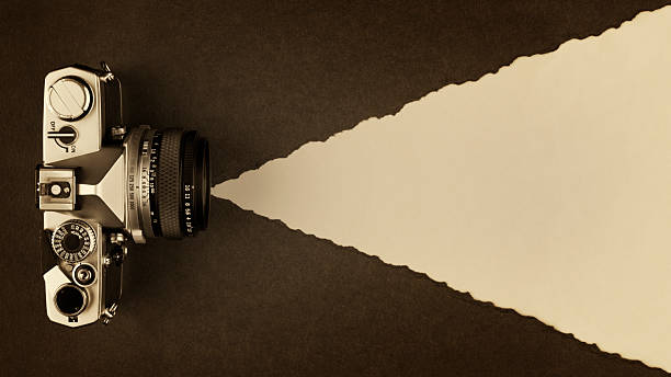 Retro Photo Camera on Sepia Toned Textured Paper Background with Copy Space