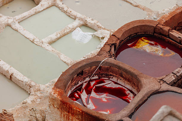 Detailed view of dye-filled stone vats used in traditional leather tanning. Rich pigments highlight the artisanal character of the historic industry.